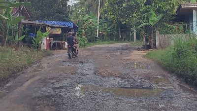 Pengendara Roda dua yang melintas dijalan Jembatan Kayu saat menghindari lubang yang mirip kubangan ikan (Katakita.co)
